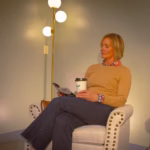 client in lobby in chair on phone