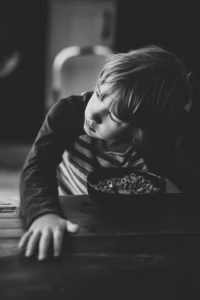 child at a table with adhd distracted over a meal